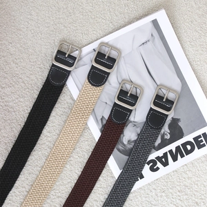 Ceintures tressées élastiques en quatre couleurs avec boucles en métal sur fond blanc
