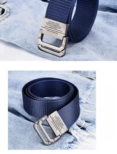 Detail of navy blue canvas belt with brushed silver double D-ring metal buckle