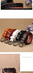 Detail of hollow sunflower pattern on vintage leather belts with metal pin buckles
