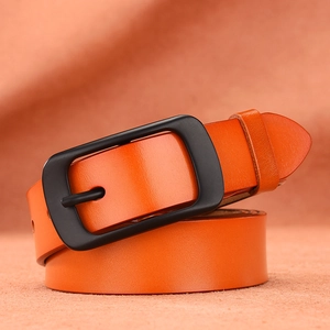 Classic orange leather belt with a matte black pin buckle on an orange background