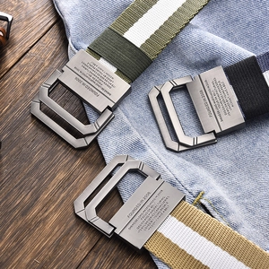 Three canvas belts with double D-ring buckles in army green, black, and khaki on denim