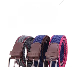 Detail of woven elastic belts in various colors featuring alloy buckles and leather ends