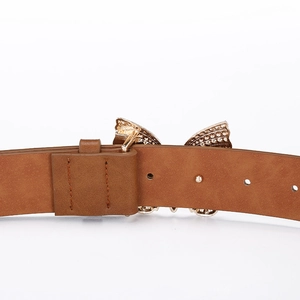 Close-up of brown leather belt with golden rhinestone butterfly buckle and punch holes