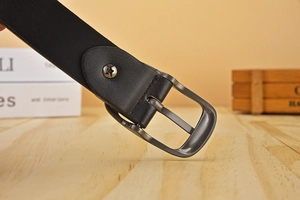Close-up of stylish black leather belt featuring a gunmetal pin buckle and textured finish
