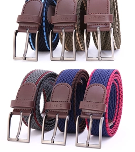 Detail showing various colors of elastic braided nylon belts with classic metal pin buckles