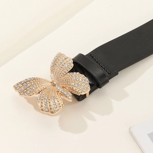 Women's black leather belt with a large gold butterfly buckle and sparkling rhinestones