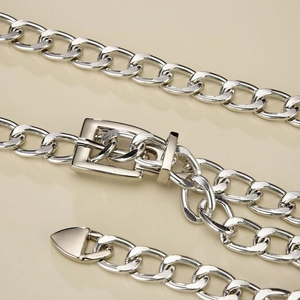 Chunky silver metal chain belt with rectangular buckle and polished industrial finish