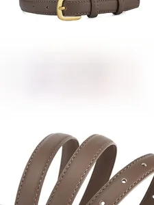 Détail d'une ceinture fine en cuir marron avec boucle dorée, grain naturel et couture