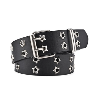 Macro shot of punk style black belt with silver star eyelets and double prong buckle
