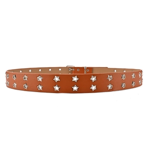 Detail showing double-row silver star grommets on a tan leather punk belt for jeans