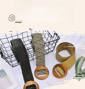 Detail view of woven stretch belts with round wooden buckles in black and khaki