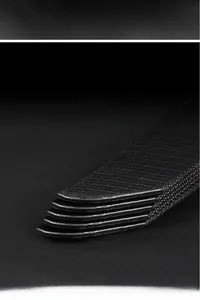 Macro shot of durable black canvas belt tips with rounded edges and anti-slip texture