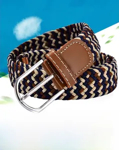 Detailed close-up of the woven texture and silver metal buckle on the elastic canvas belt