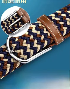 Detail of elastic woven belt featuring zinc alloy buckle and textured tri-color fabric