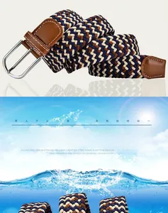 Detail of woven elastic belt with silver metal buckle and brown leather accents