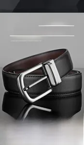 Detail view of men's black leather belt with silver brushed buckle and cross pattern texture