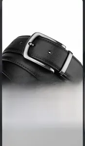 Detail of black leather belt featuring a textured braided pattern and silver pin buckle