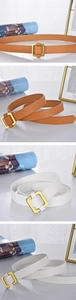 Close-up of minimalist square gold buckles and smooth PU leather straps in tan and cream