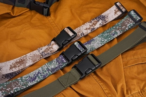 Close-up of military camouflage canvas belts with durable plastic buckles for outdoors