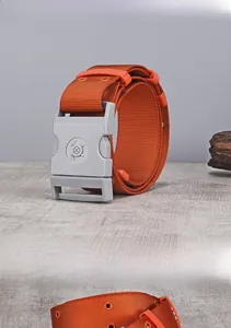 Close-up of orange tactical nylon belt with durable plastic buckle and metal eyelets