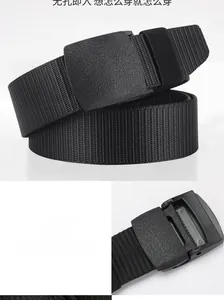 Detail of black woven canvas belt featuring a matte plastic buckle and tooth closure