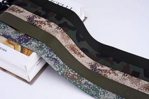 Detailed view of durable canvas military belts in various camouflage and olive patterns