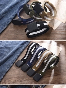 Close-up of assorted striped canvas belts with matte plastic buckles on a wooden table