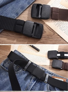 Detail of durable nylon tactical belts with plastic buckles on casual denim jeans