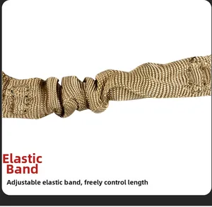 Detail of khaki elastic webbing on tactical sling showing adjustable bungee texture