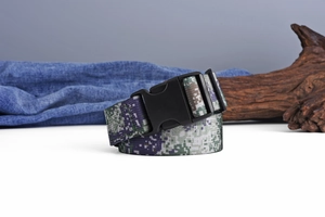 Close-up of tactical nylon belt with digital camouflage pattern and black plastic buckle