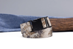 Macro shot of digital camouflage nylon strap and durable black plastic buckle on military belt