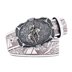 Detail of western cowboy rodeo buckle with embossed floral leather belt and silver horse carving