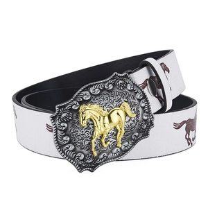 Detail of western cowboy belt buckle featuring a golden horse with floral relief engraving