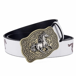 Detail of western cowboy belt with horse pattern and vintage engraved buckle