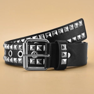 Detailed macro view of three rows of silver square rivets on a black punk leather belt