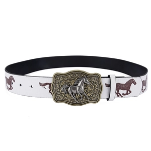 Detailed close-up of a vintage western belt buckle with horse relief and floral engraving