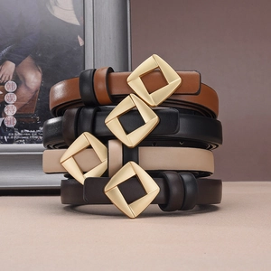Detail of four colorful thin leather belts for women with minimal gold metal buckles
