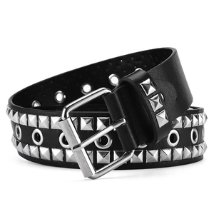 Detail of black punk Y2K belt featuring silver pyramid studs and metallic grommets