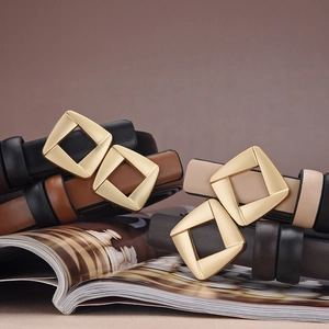 Macro detail of elegant slim leather belts in four colors with golden geometric buckles