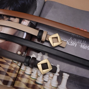 Flat lay of thin leather belts in four colors with gold square buckles on trendy magazine