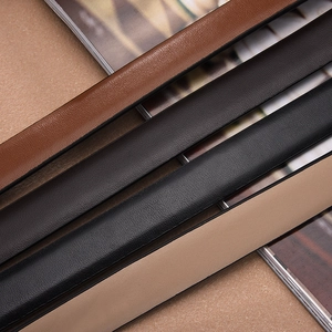 Close-up of four thin leather belts in tan, coffee, black, and beige with grain texture