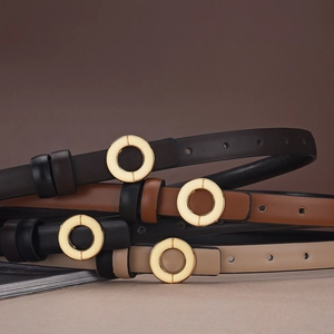 Detail view of slim leather belts with round gold buckles in four classic colors