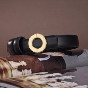 Minimalist black leather belt for women featuring a polished gold round metal buckle