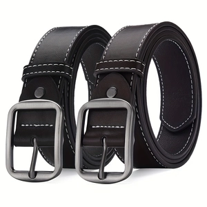 Detail of classic pin buckle belts in black and dark brown with white decorative stitching