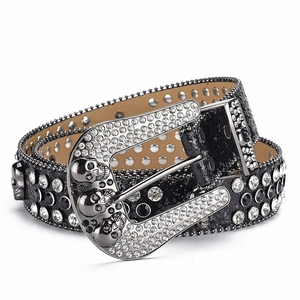 Detail of punk style rhinestone belt featuring skull metal buckle with sparkling crystals