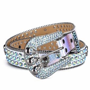 Macro shot of skull buckle with blue rhinestones and iridescent studded leather belt
