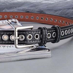 Punk style black leather belt with silver metal grommets and contrast stitching