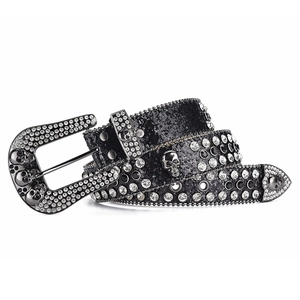 Close-up of gothic rhinestone belt with metal skull hardware and sparkling black sequins