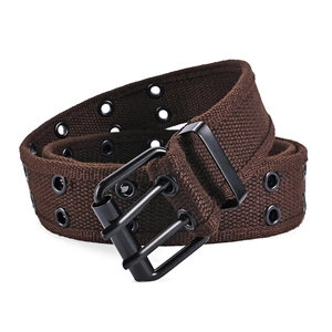 Detailed close-up of brown canvas belt with double metal eyelets and black pin buckle