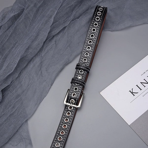 Detail of black grommet belt with silver eyelets and white contrast stitching detail
